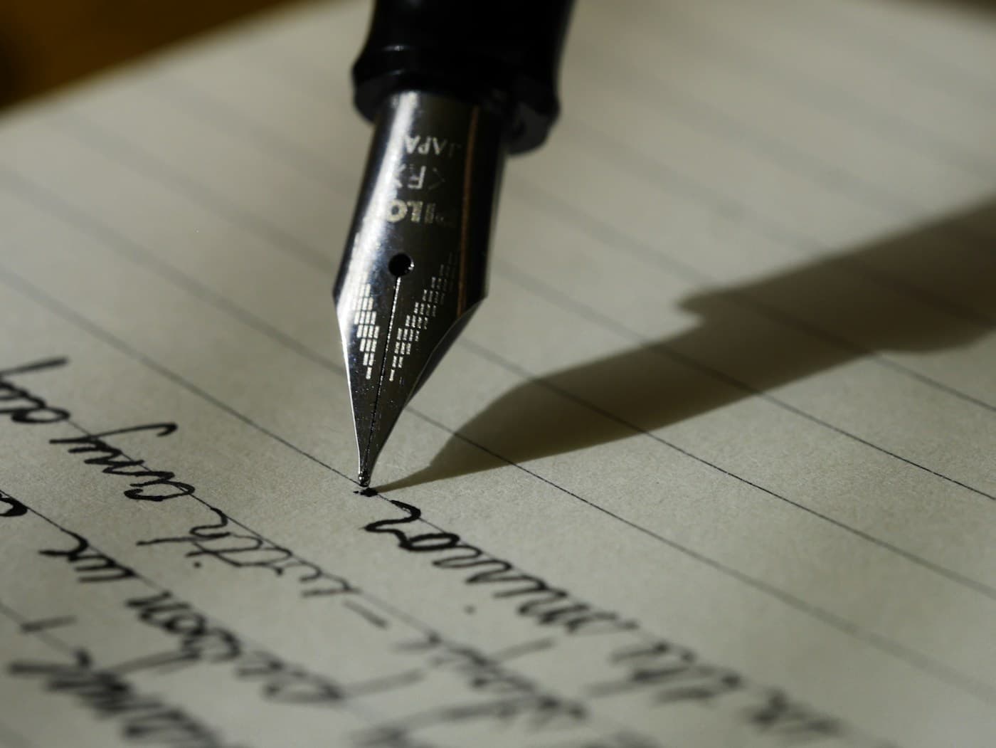 A fountain pen resting on a handwritten page